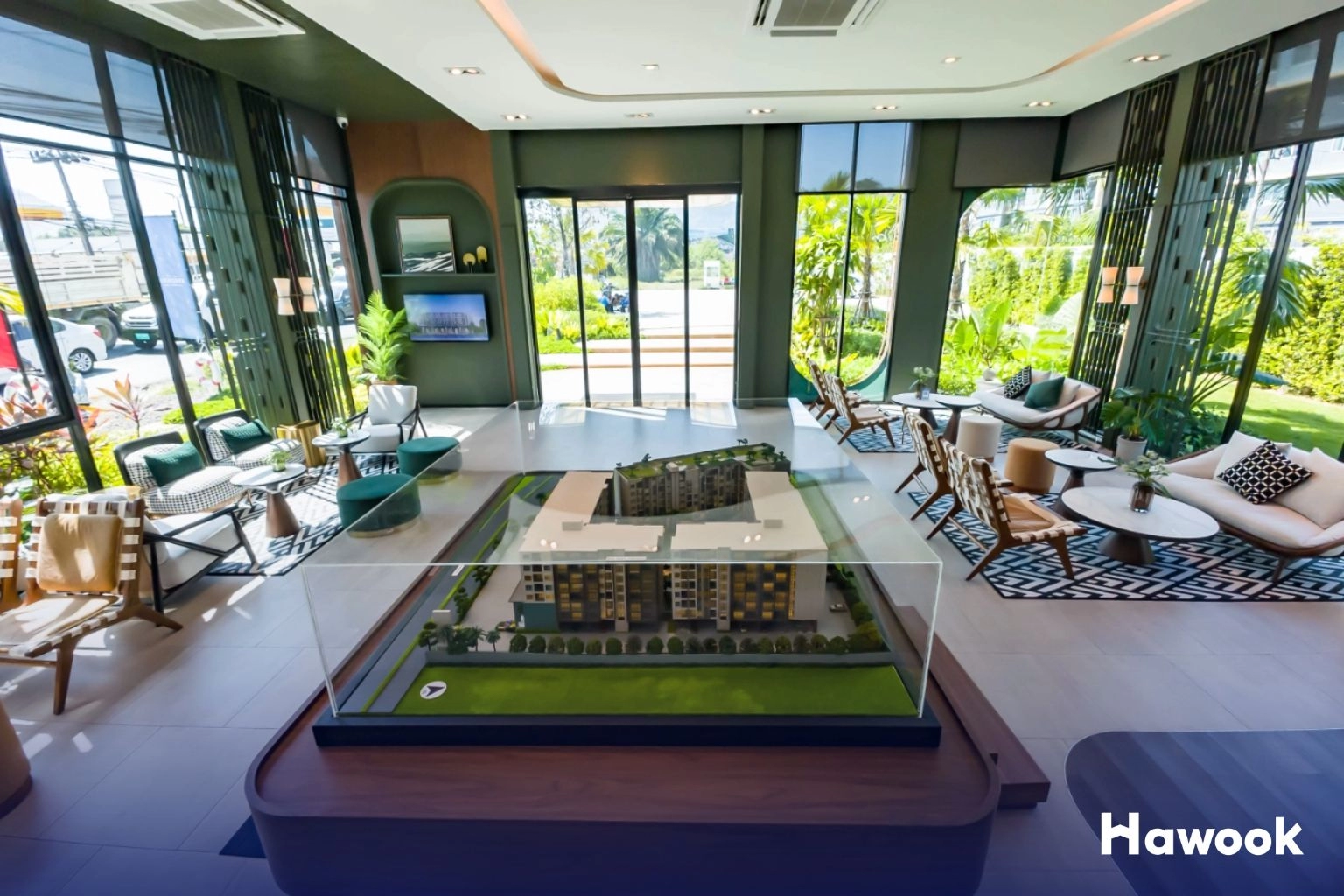 Modern sales gallery in Thailand with condo scale model and lounge area