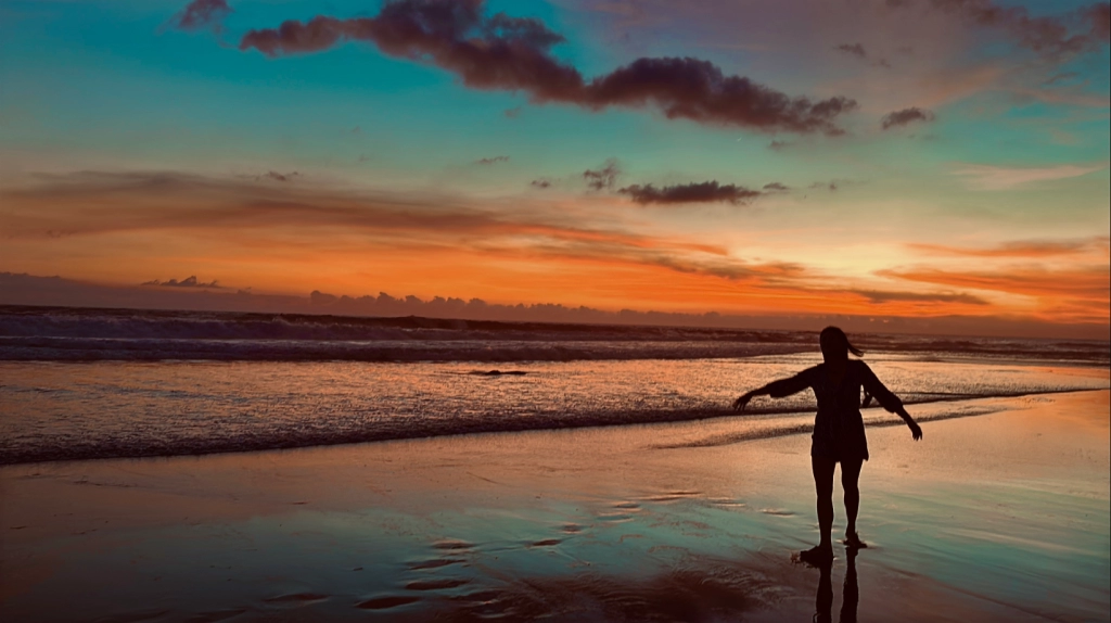 💰 Investing Guides | Phuket vs Bali vs Vietnam – Where to Invest? A silhouette walking along Echo Beach in Canggu, Bali at sunset — a prime location in Bali’s property investment landscape.