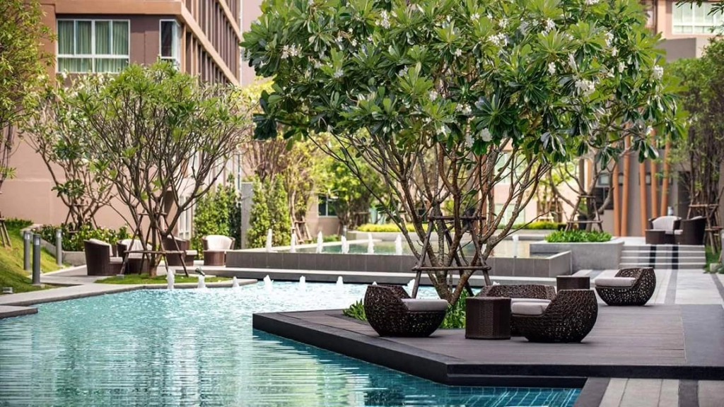 Completed condo project in Phuket showing landscaped pool area and modern design, illustrating strong developer track record