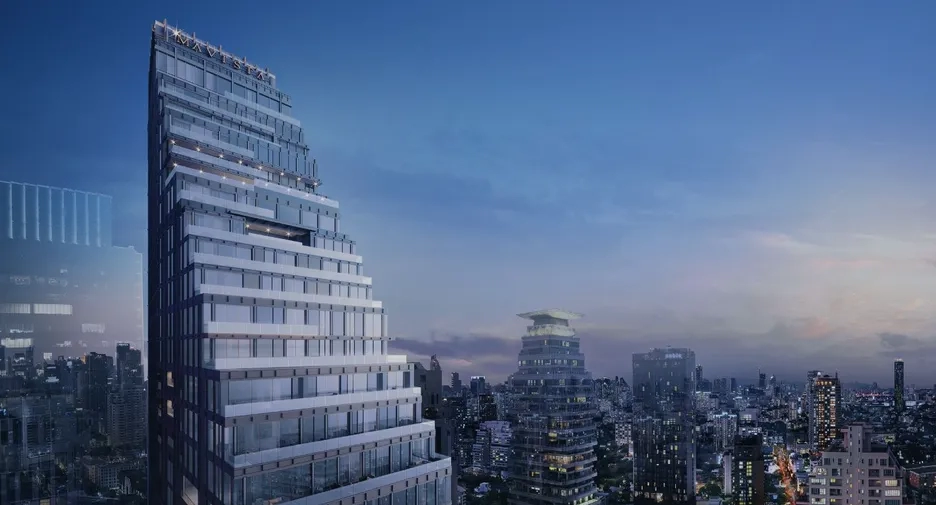 Modern high-rise condominium in Bangkok at dusk, with the city skyline in the background highlighting premium real estate opportunities.
