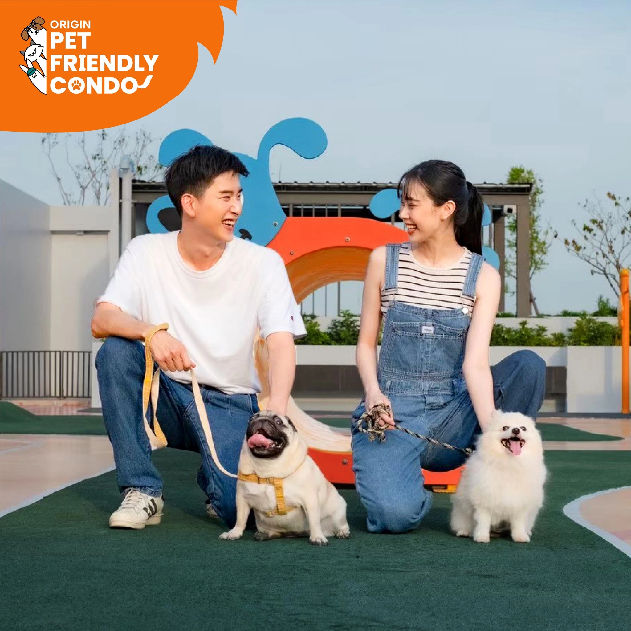 Couple with dogs enjoying outdoor play area at Origin Pet Friendly Condo