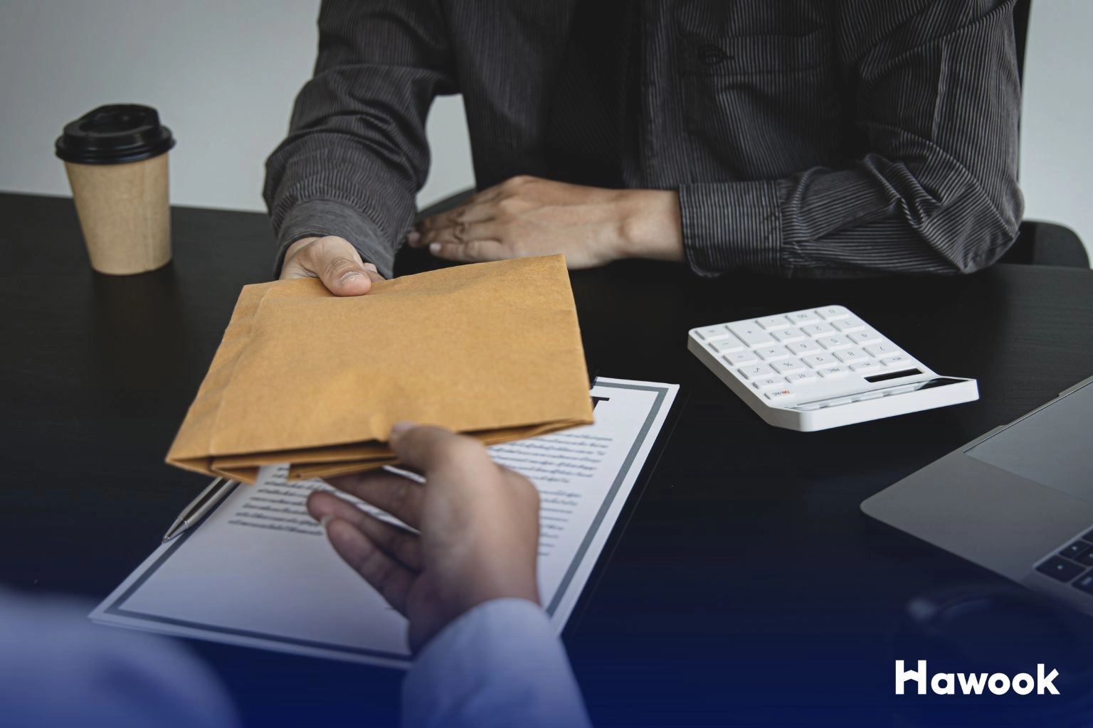 Man handing over an envelope during suspicious property transaction – how to avoid common property scams in Thailand