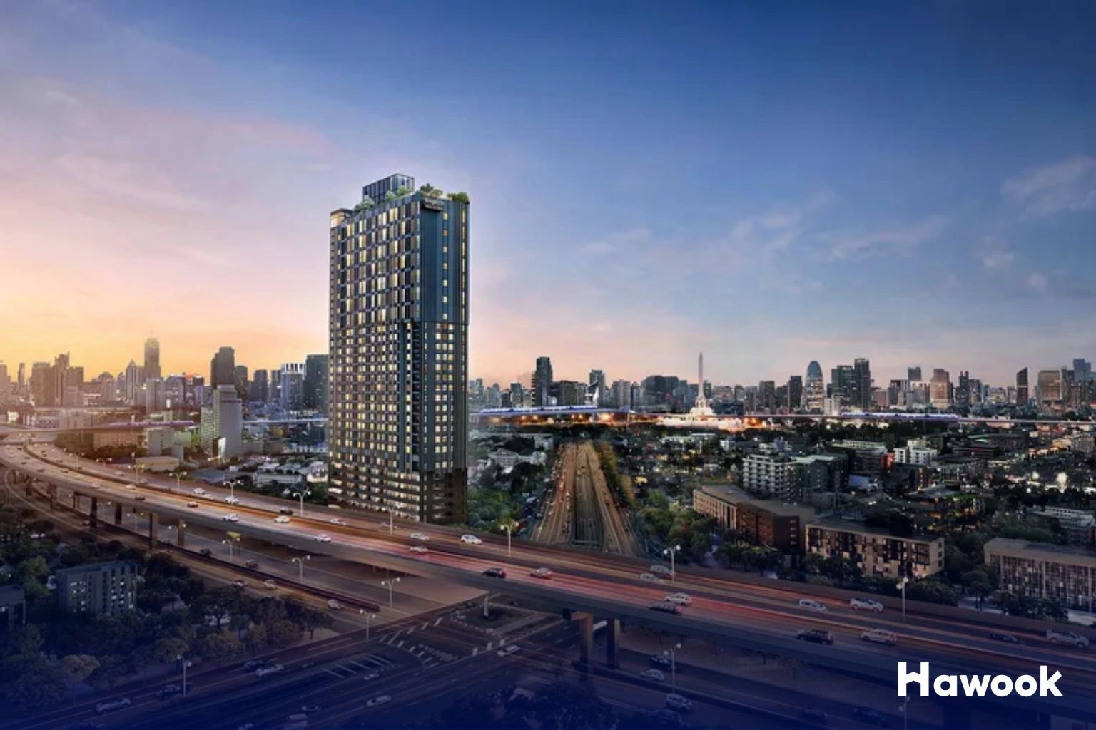 Bangkok condo high-rise tower with highway and city skyline at sunset