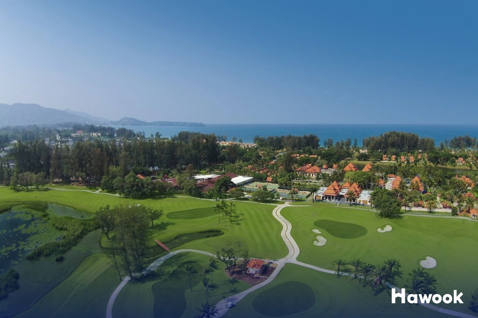 Aerial view of Bangtao Beach and Laguna golf course in Phuket showcasing luxury real estate and tropical lifestyle.