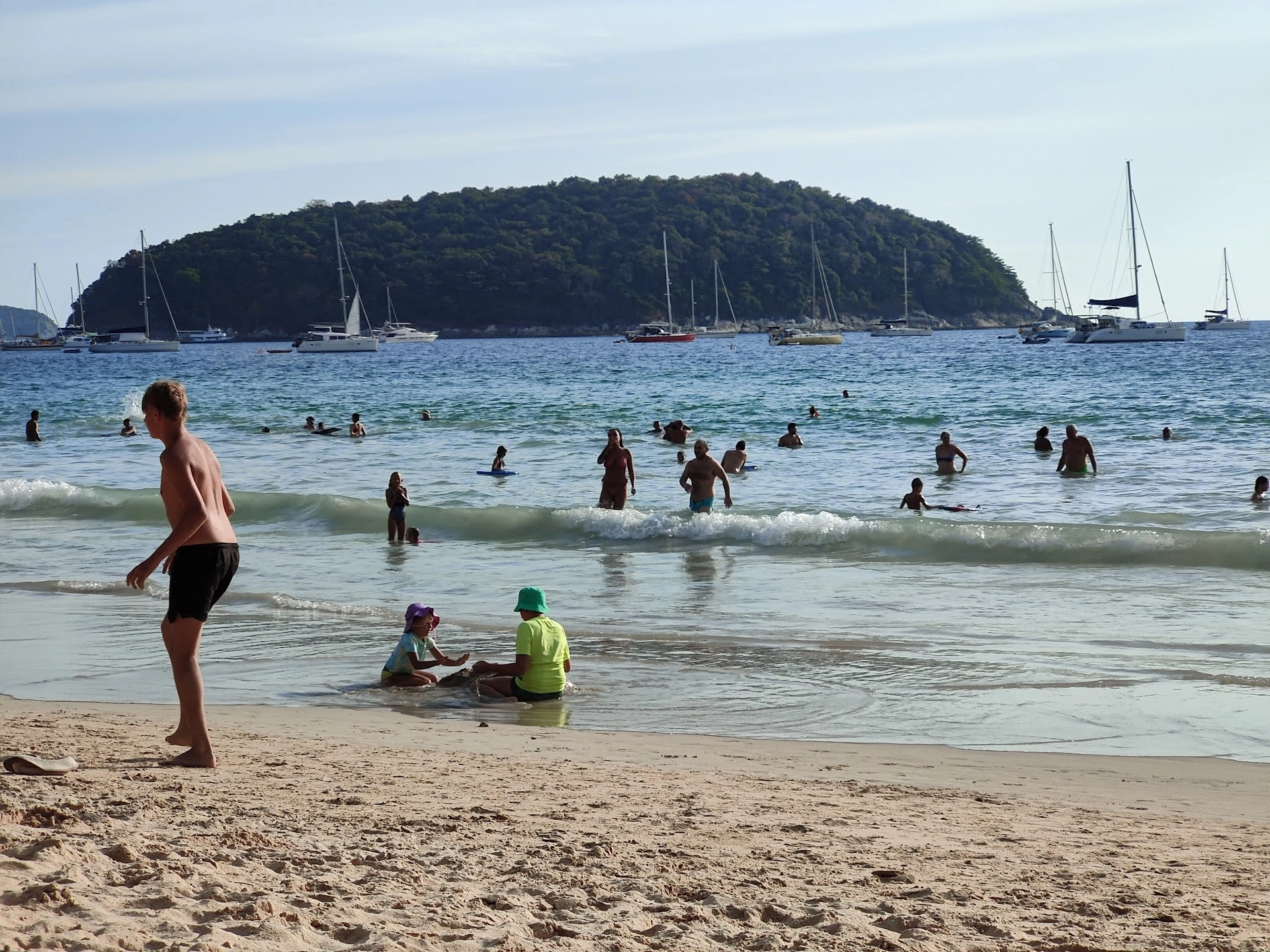 Tourists enjoying the beach in Phuket, showing how tourism drives property supply in 2025