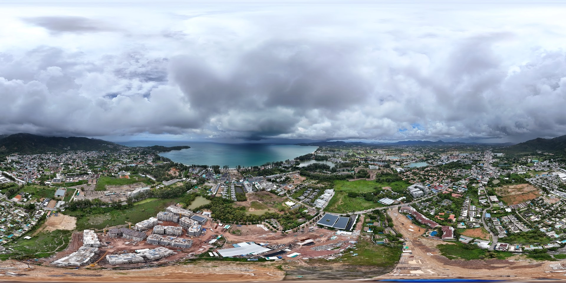 💰 Investing Guides, 📍 Neighborhood Guides | Bangtao Property Market 2025 – Trends and ROI Aerial view of the Bangtao property market in Phuket with new condo projects under construction near the beach.
