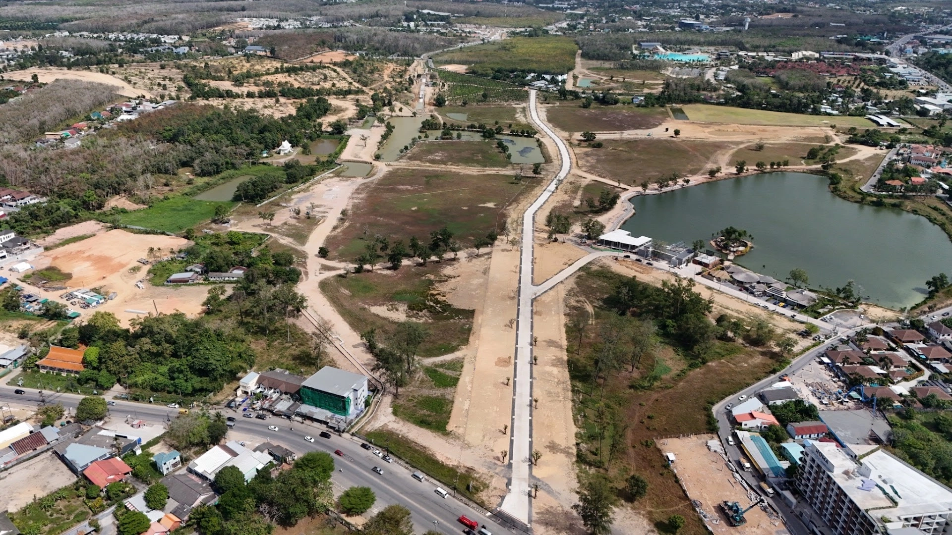 📍 Neighborhood Guides | Bangtao Real Estate Guide 2025 | Condos, Villas & ROI Aerial view of Bangtao and Cherngtalay showing new real estate developments, roads, and lakes in Phuket.
