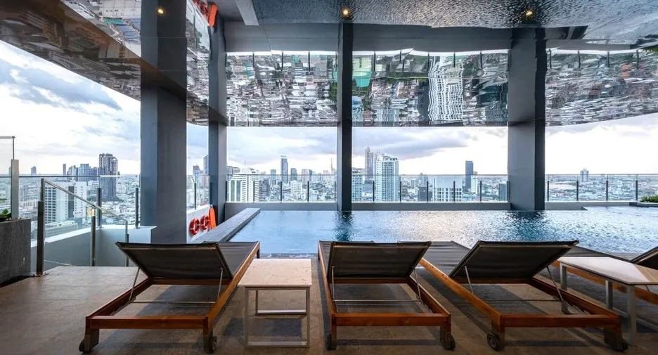 π° Investing Guides | Thailand Property Investment vs. S&P 500: Why Investors Still Buy Luxury Bangkok condo rooftop pool overlooking the skyline β Thailand Property Investment