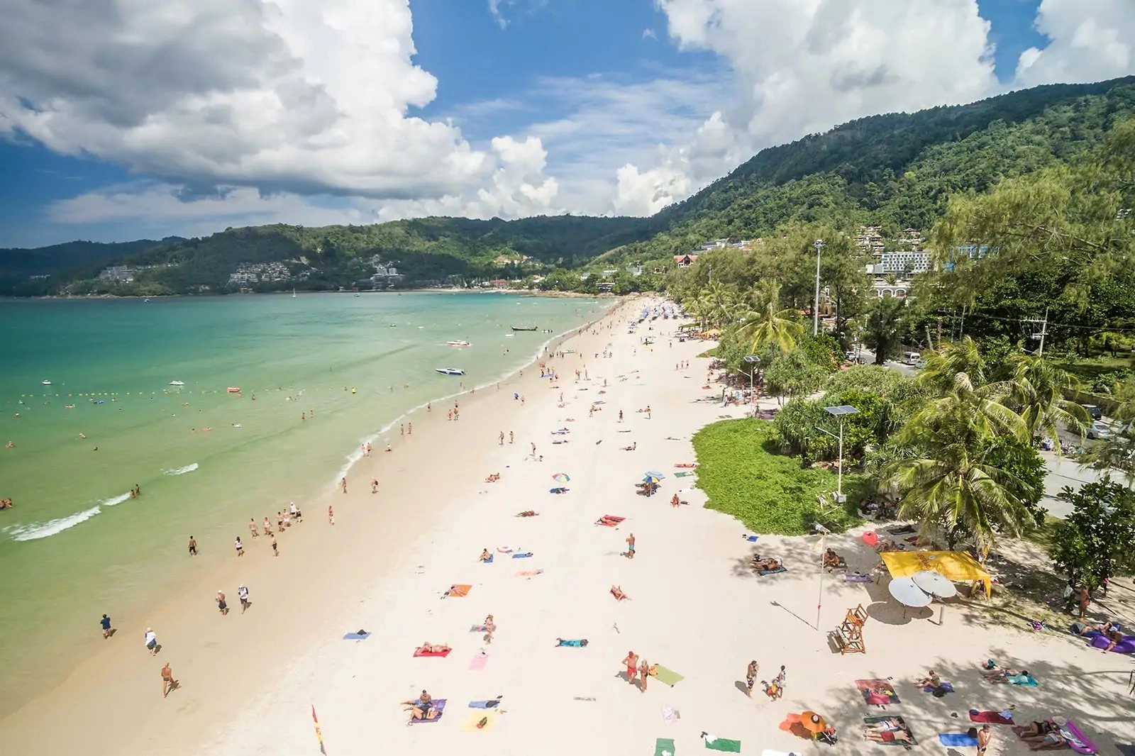 Aerial view of Patong Beach in Phuket during high season, showing busy shoreline and strong tourism activity linked to Phuket Property Investment demand.