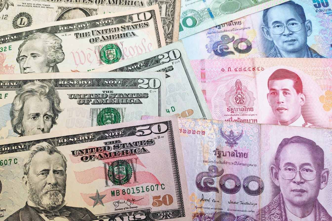 Thai baht and US dollar banknotes showing currency risk in overseas property investment