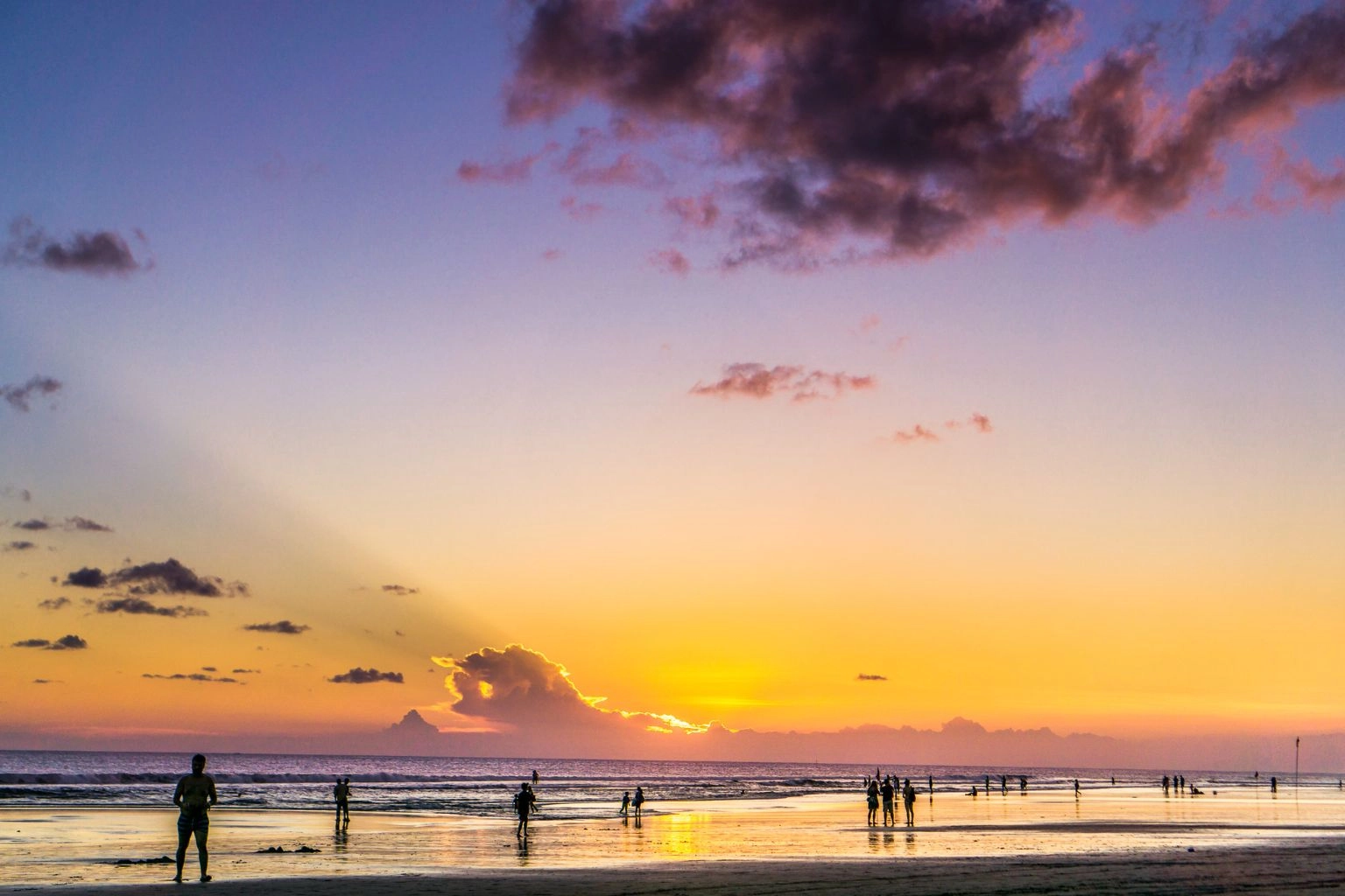 Quiet beach in Phuket during low season with few tourists at sunset, reflecting Airbnb pricing strategy timing