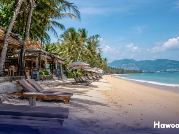 Beachfront restaurants and sun loungers along Bang Tao Beach in Phuket before the Bang Tao land seizure crackdown