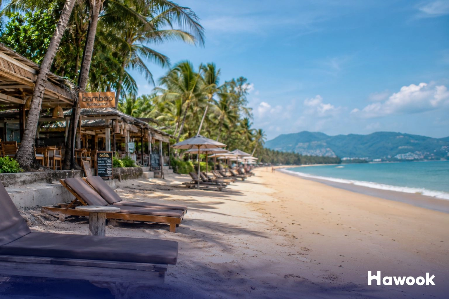 Beachfront restaurants and sun loungers along Bang Tao Beach in Phuket before the Bang Tao land seizure crackdown